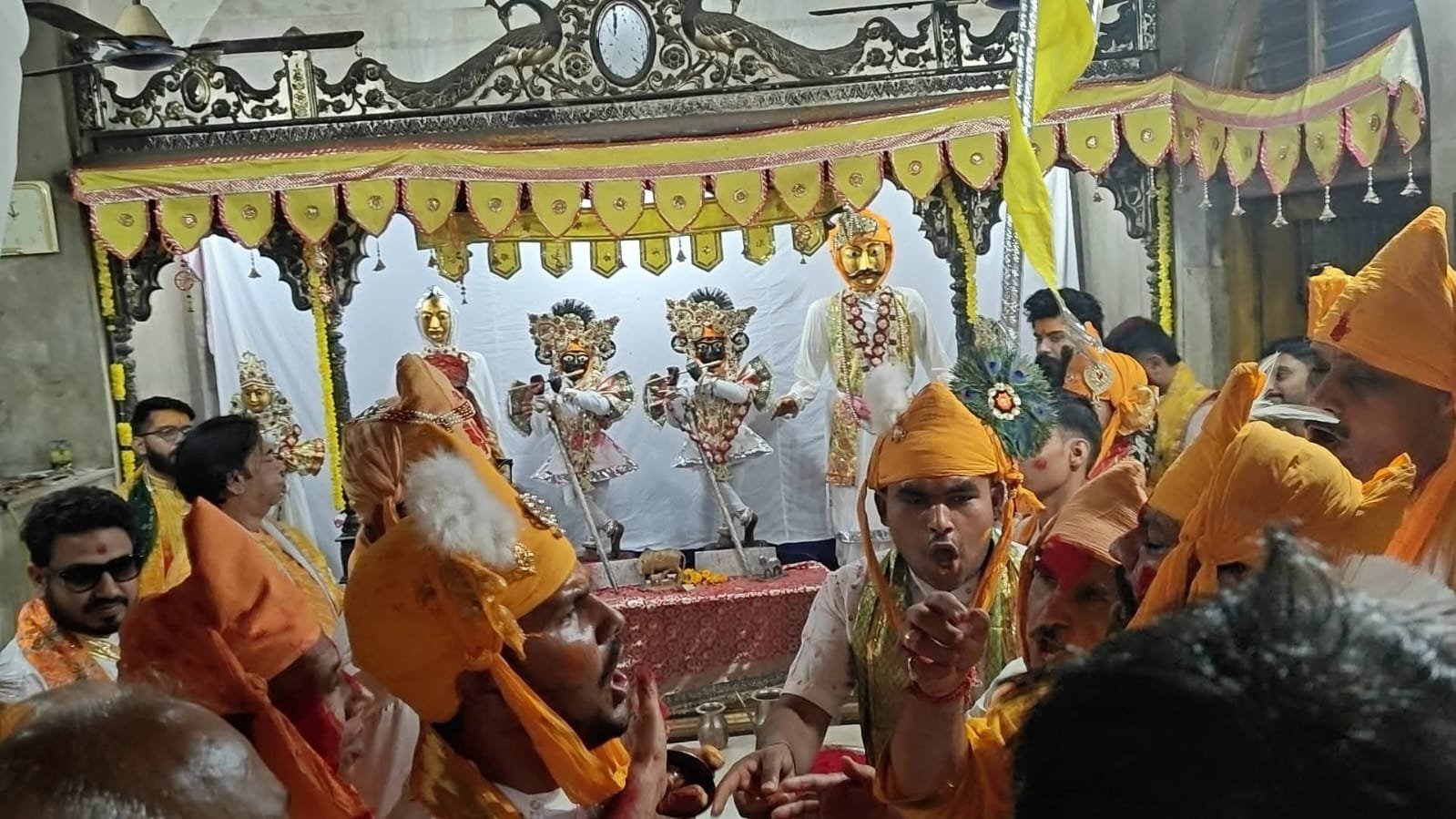 Women (Sakhis) striking Huriyars with sticks during Lathmar Holi at Nandgaon’s Rangili Chowk as colored gulal fills the air, February 26, 2026