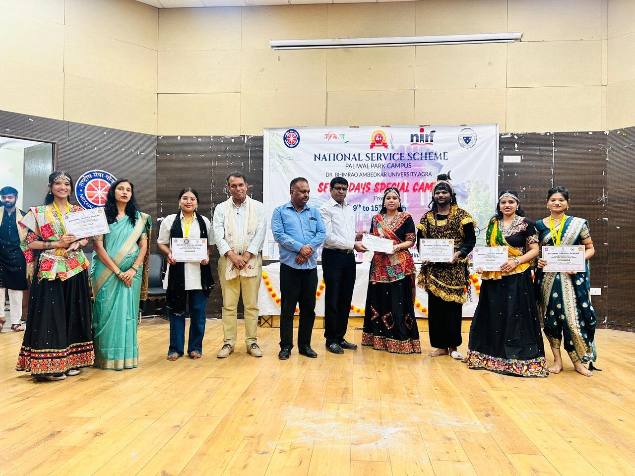 Students participating in the seven-day National Service Scheme (NSS) camp closure event with cultural performances at Dr. Bhimrao Ambedkar University, Agra, including dances, skits, and presentations by volunteers
