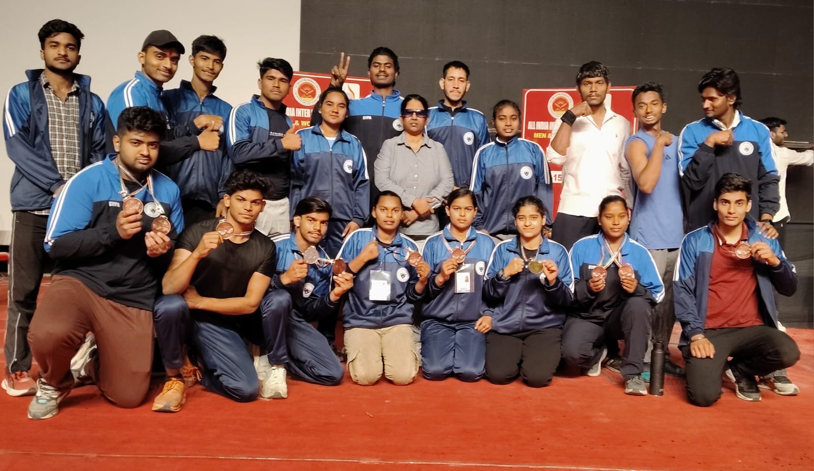 Players of Dr. Bhimrao Ambedkar University, Agra celebrating after winning 11 medals in the All India Inter University Arm Wrestling Tournament held at Raja Mahendra Pratap Singh State University, Aligarh from 10th to 15th March 2026, including gold, silver, and bronze medalists