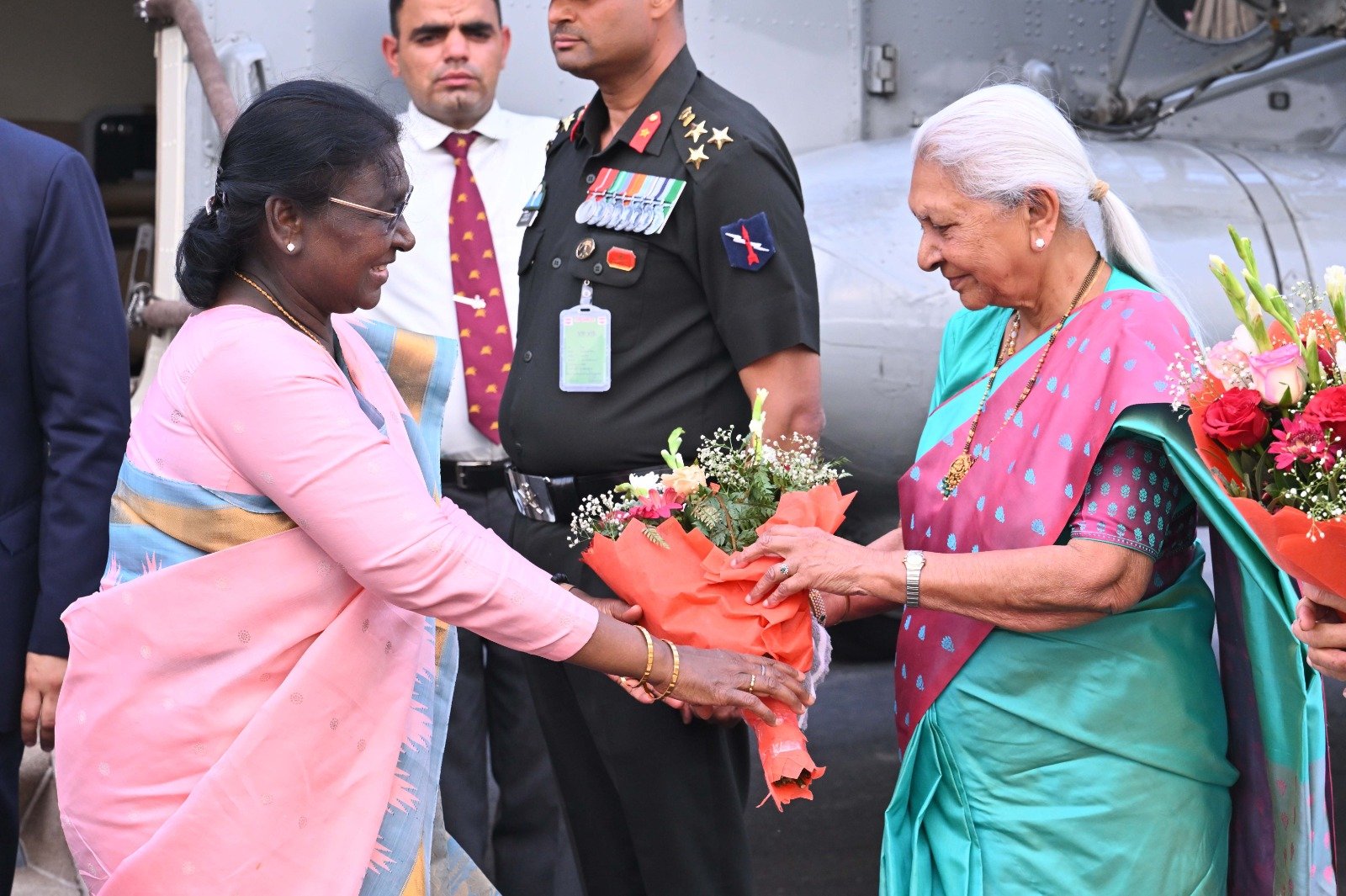 President Draupadi Murmu arriving in Mathura and being welcomed by Governor Anandiben Patel and officials at the helipad