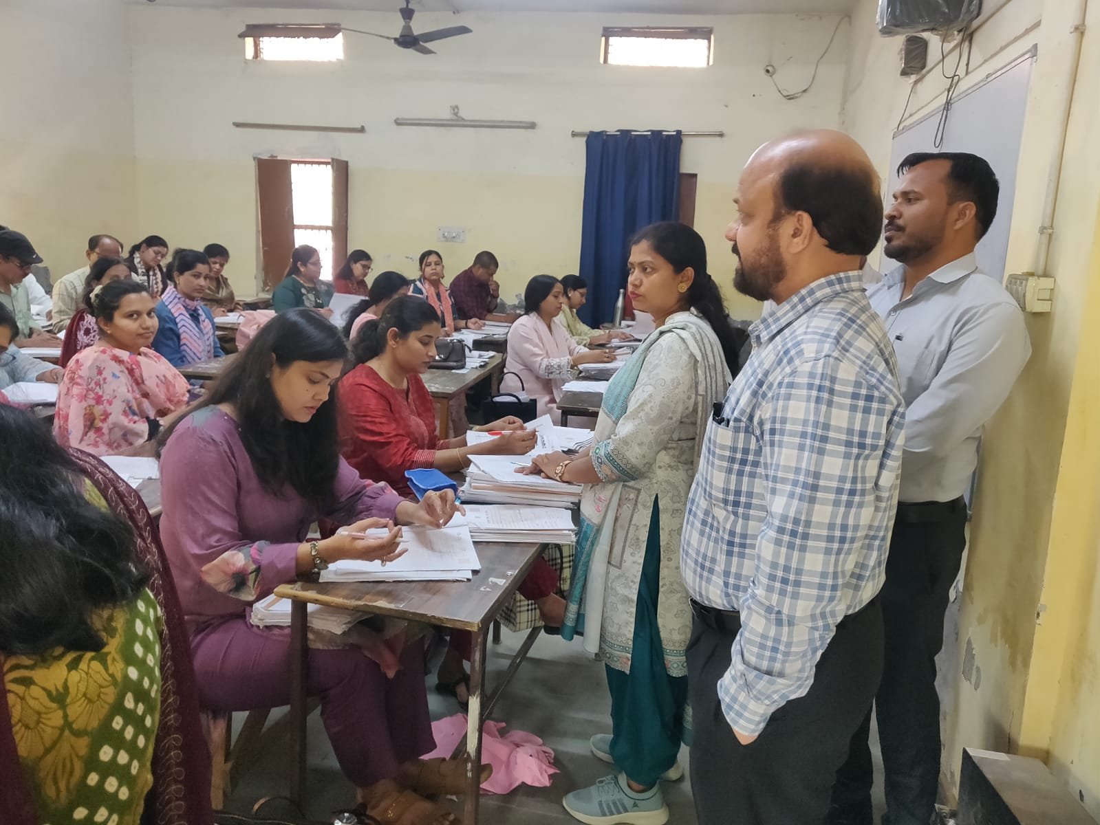 Joint Education Director inspecting answer sheet evaluation process at a centre in Agra
