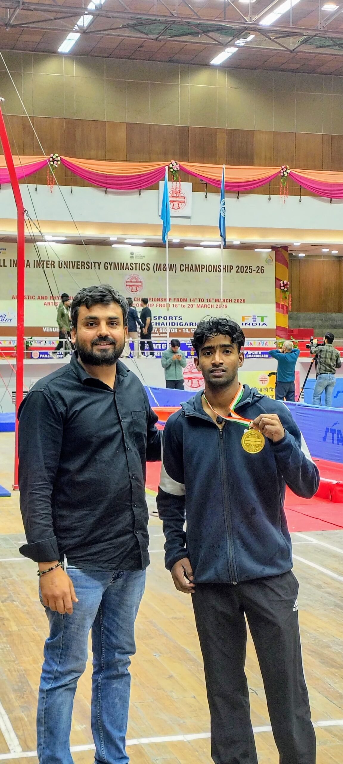 Rizwan, a student of Dr. Bhimrao Ambedkar University Agra, holding a gold medal after winning the high bar event in All India Inter University Gymnastics competition at Panjab University Chandigarh