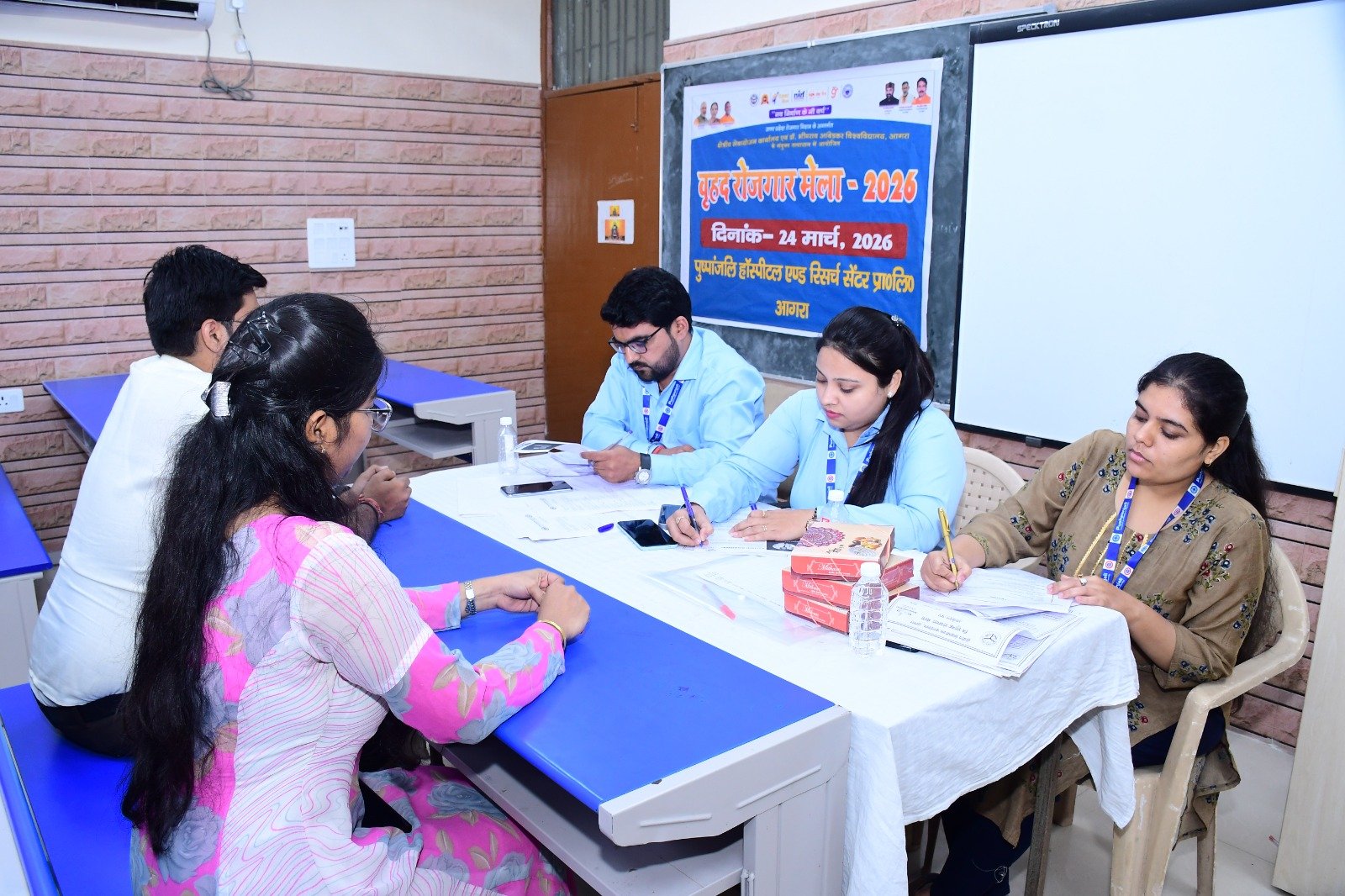 Students and job seekers attending the mega job fair at Dr. Bhimrao Ambedkar University Agra interacting with company recruiters during placement drive