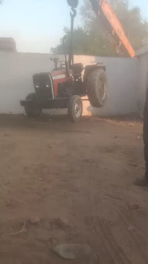 Farmers using a hydra machine to pull out tractor trolleys stuck inside a locked cold storage in Fatehabad