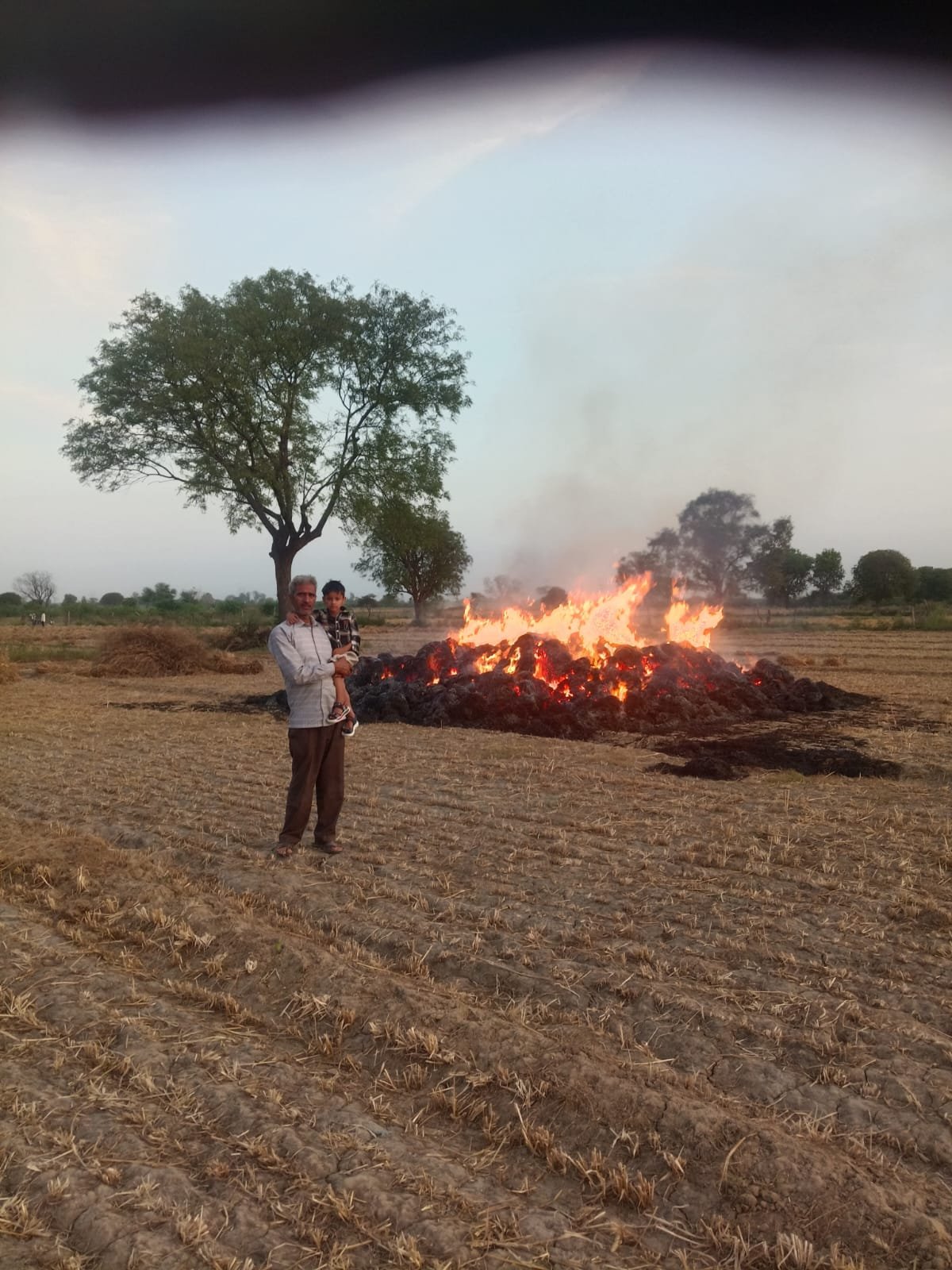 Farmer watching his wheat stack burning in a massive fire incident in Nagla Hiraman village Agra