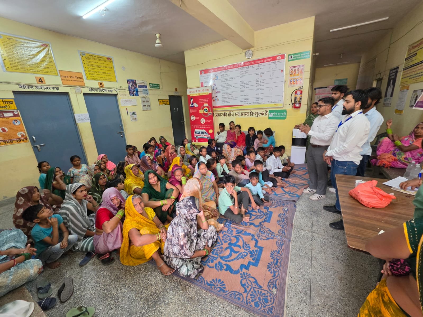 Students of Dr. Bhimrao Ambedkar University conducting a free health camp and awareness program in Malpura village, Agra, providing medical checkups, vaccination for children, and health guidance for women.