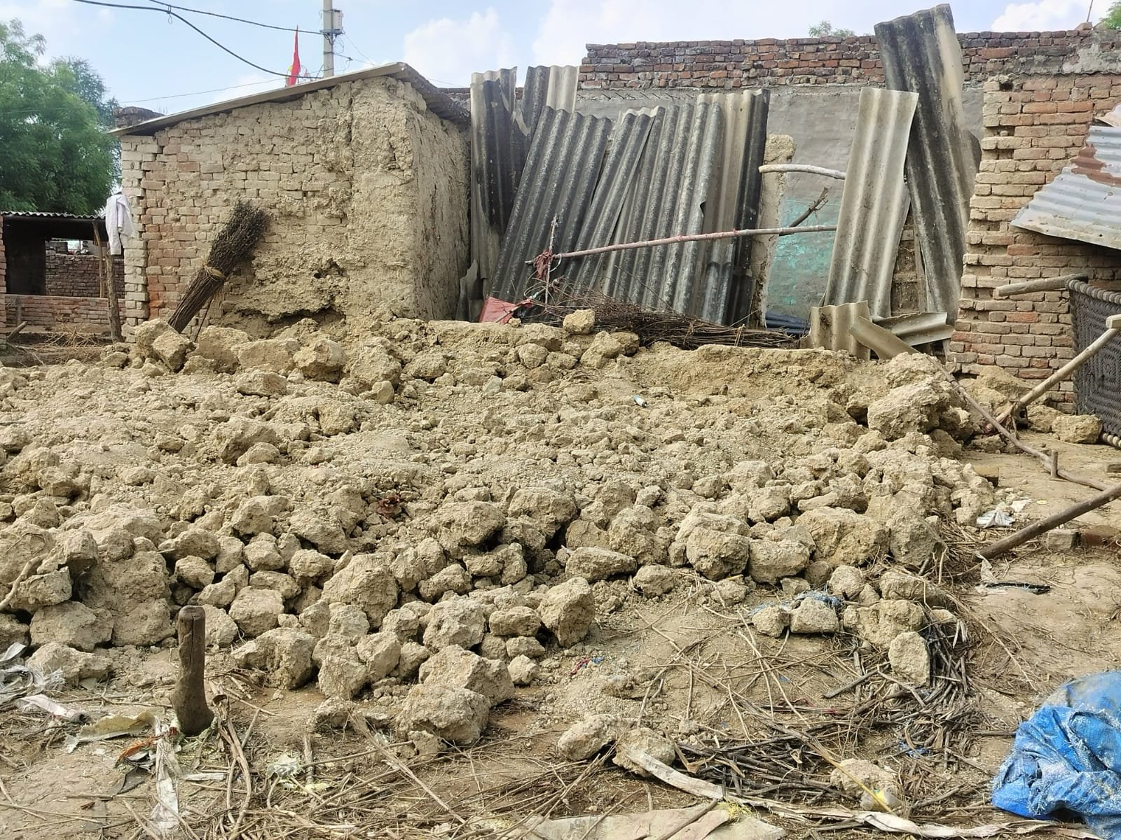 Villagers removing debris after a mud wall collapsed due to rain killing seven goats in Thipuri village Fatehabad Agra