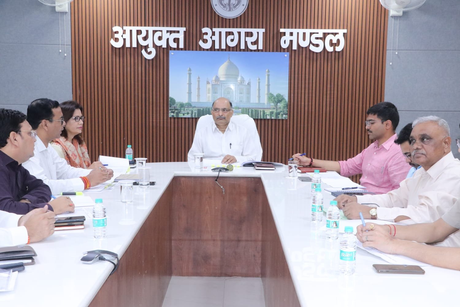 Divisional Commissioner chairing transport authority meeting regarding school vehicle fitness and permit suspension in Agra