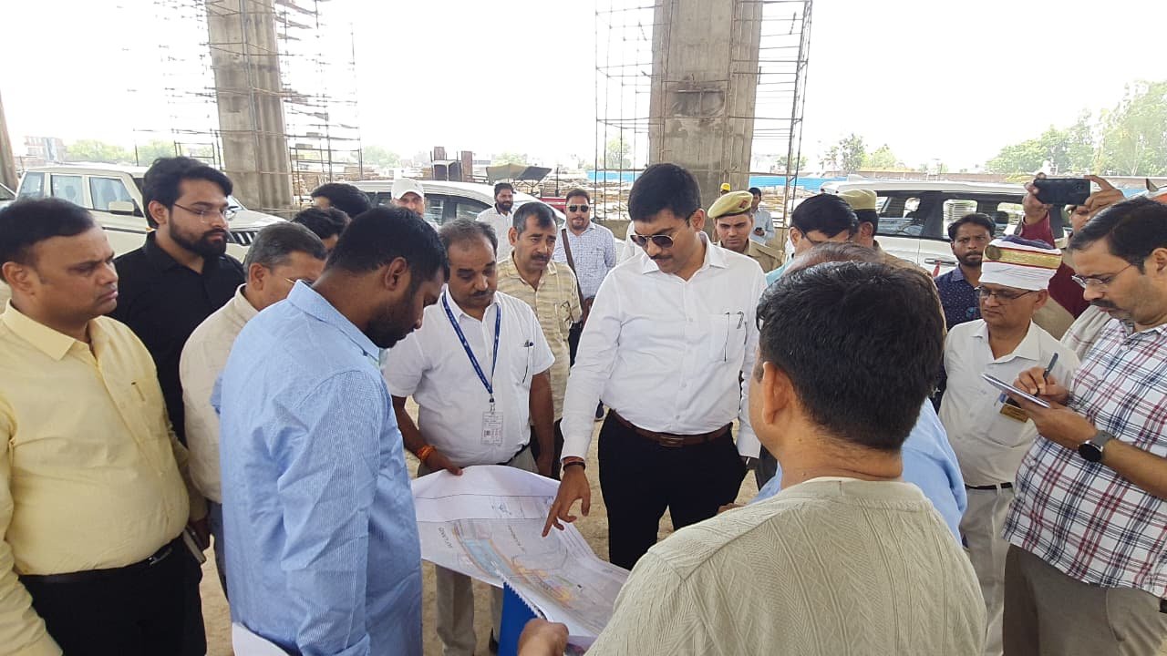 District Magistrate Manish Bansal inspecting the under-construction Agra Civil Airport Terminal project, reviewing runway, terminal building, and infrastructure development work with officials.