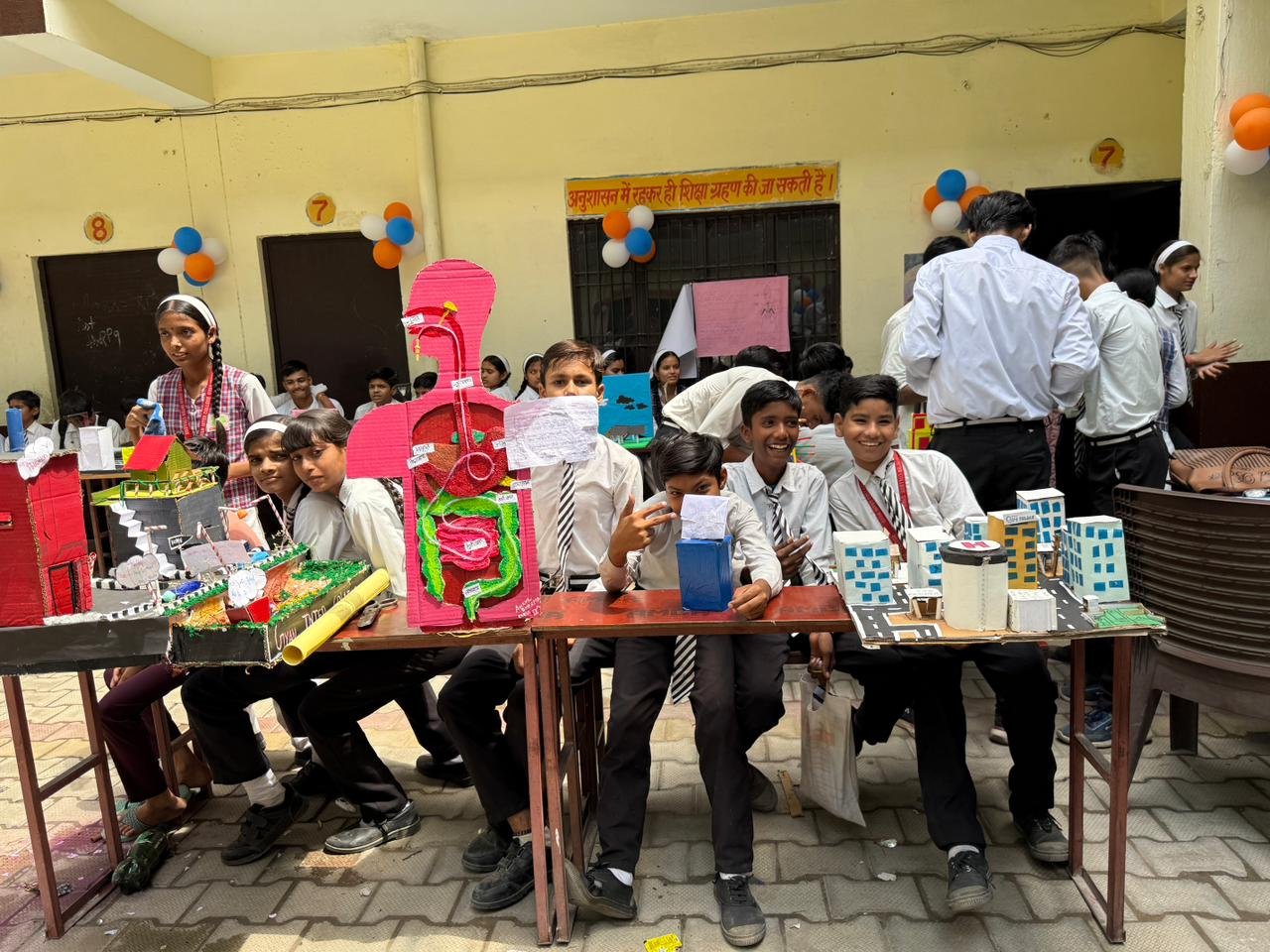 Science exhibition photography showing students presenting innovative models at Knowledge Inter College Agra event