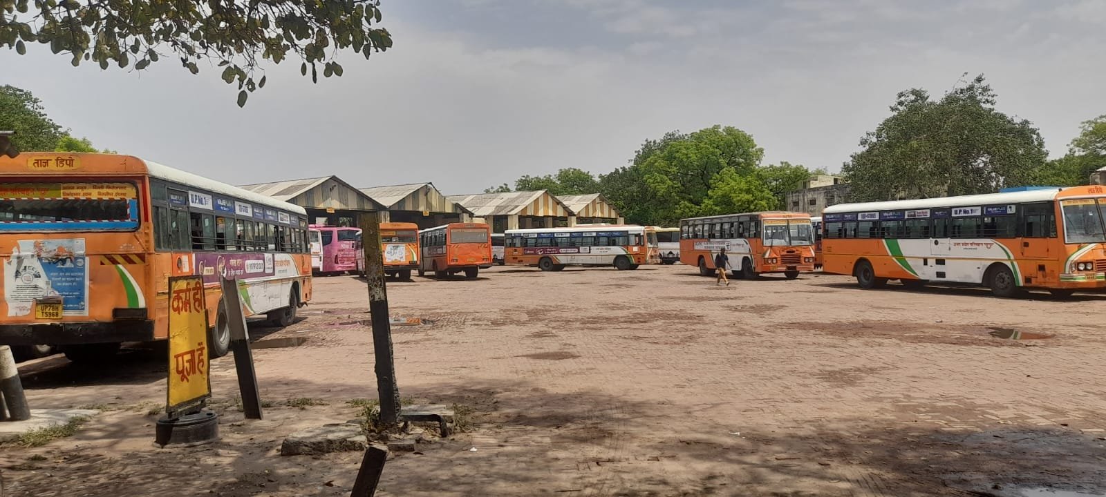 Non-operational buses parked at Taj Depot Agra with missing tyres and awaiting maintenance in workshop