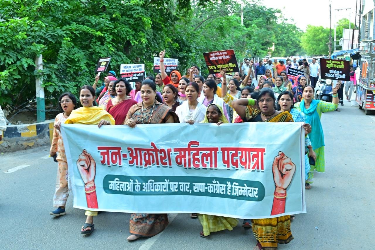 Women participating in Jan Aakrosh Yatra procession in Agra raising slogans during protest march led by BJP leaders