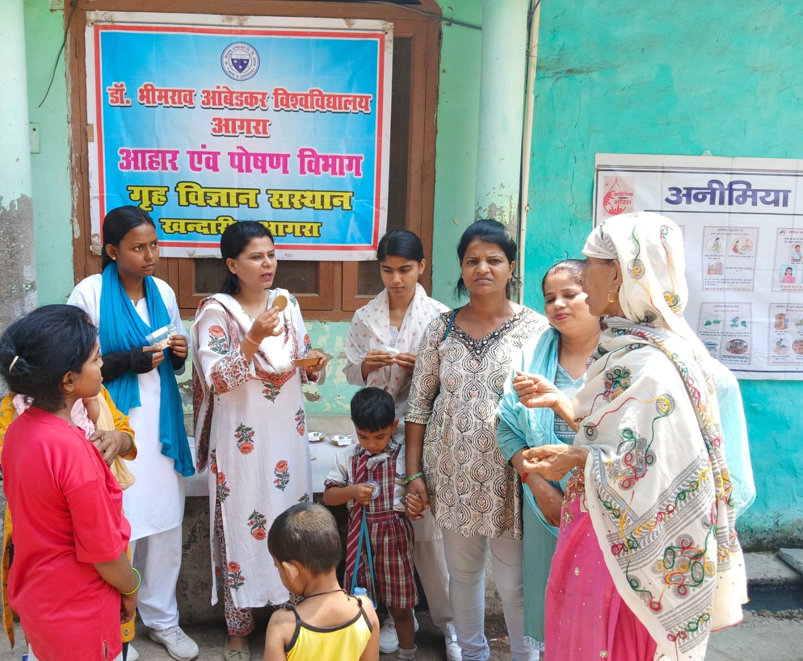 Students of Dr. Bhimrao Ambedkar University conducting community nutrition awareness program in Khandaari area Agra, preparing low-cost protein and iron rich food products for women and children