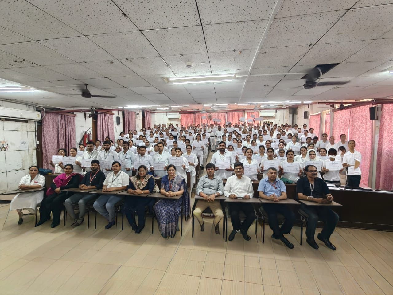 Group of 193 newly appointed nursing officers standing with Principal and senior medical staff during induction training program at SN Medical College