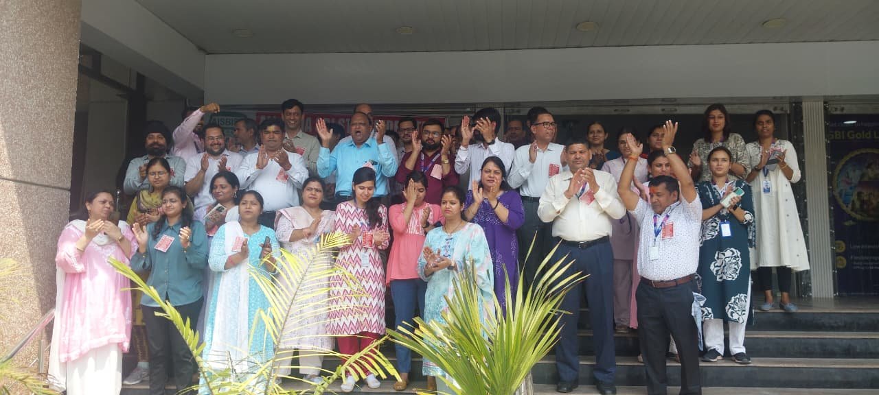 State Bank of India employees protesting outside the SBI Administrative Office in Sanjay Place, Agra, demanding recruitment, staff security, and an end to outsourcing policies.