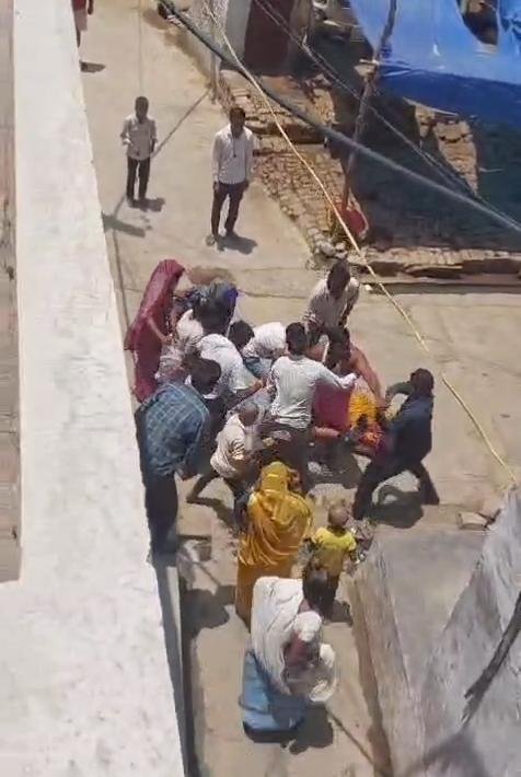 People gathered during an assault incident involving a woman over a money dispute in Nibohra area of Fatehabad