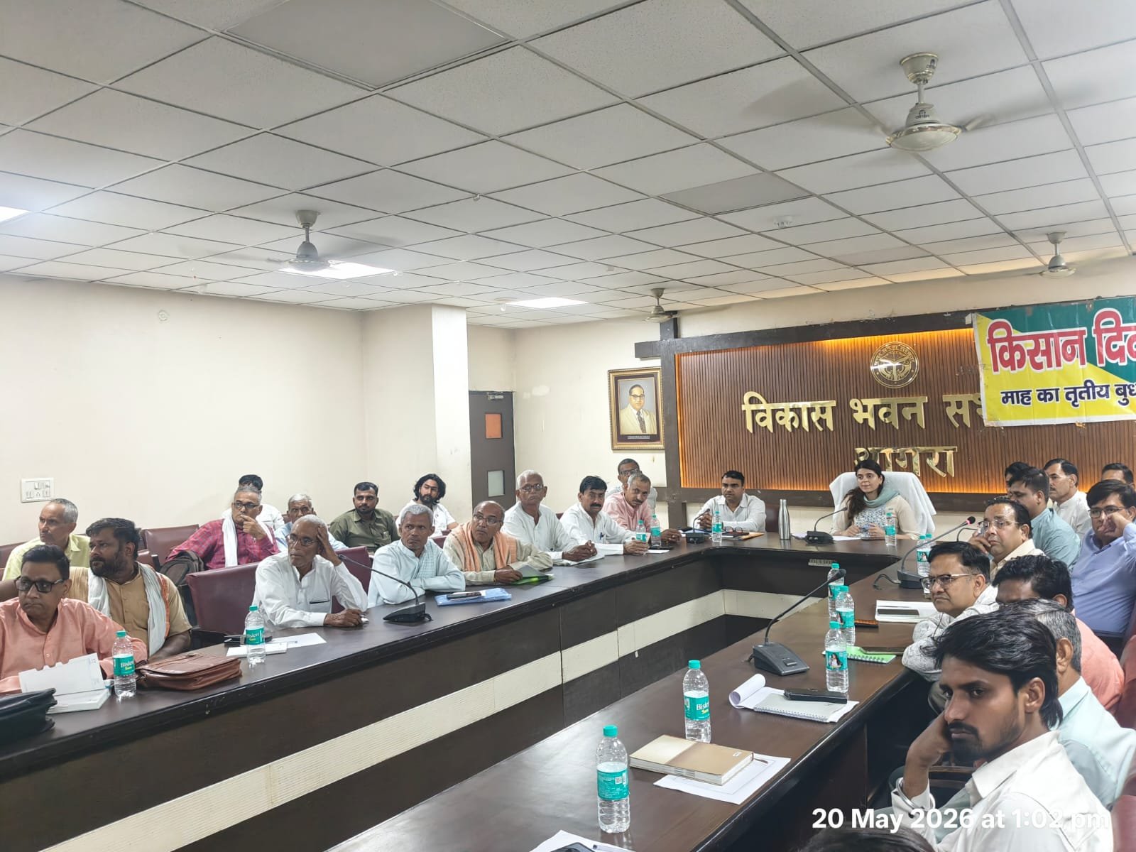 Farmers and agriculture officials attending a Farmer Day program at Vikas Bhawan auditorium in Agra discussing modern farming techniques.
