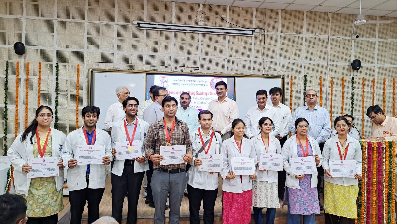 Doctors and medical students being honored during a healthcare service recognition ceremony at SN Medical College Agra