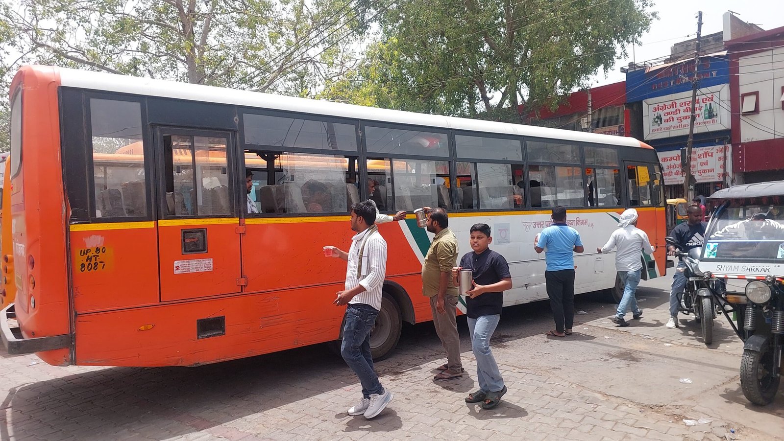 Social workers distributing cold sharbat to passengers and travelers at Fatehabad bus stand on Ganga Dussehra