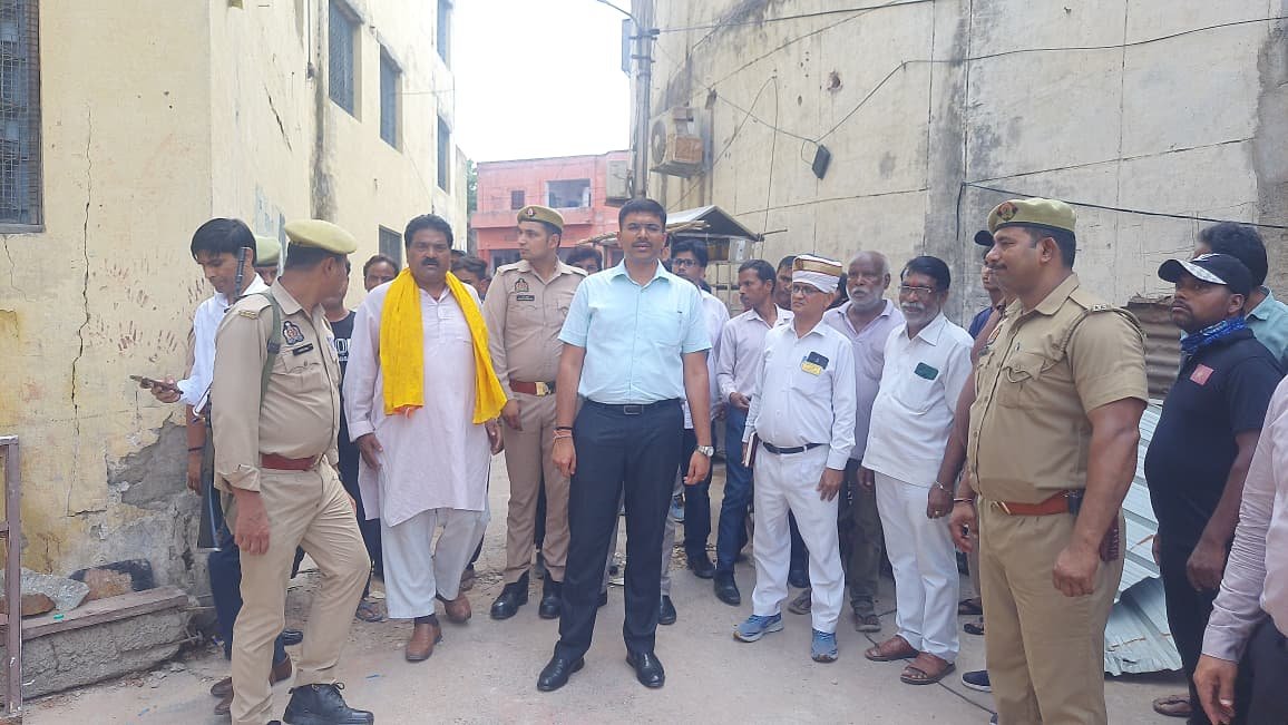 District Magistrate Manish Bansal inspecting Beni Singh Vaidik Vidyawati Inter College in Agra after heavy rainfall and structural damage concerns.