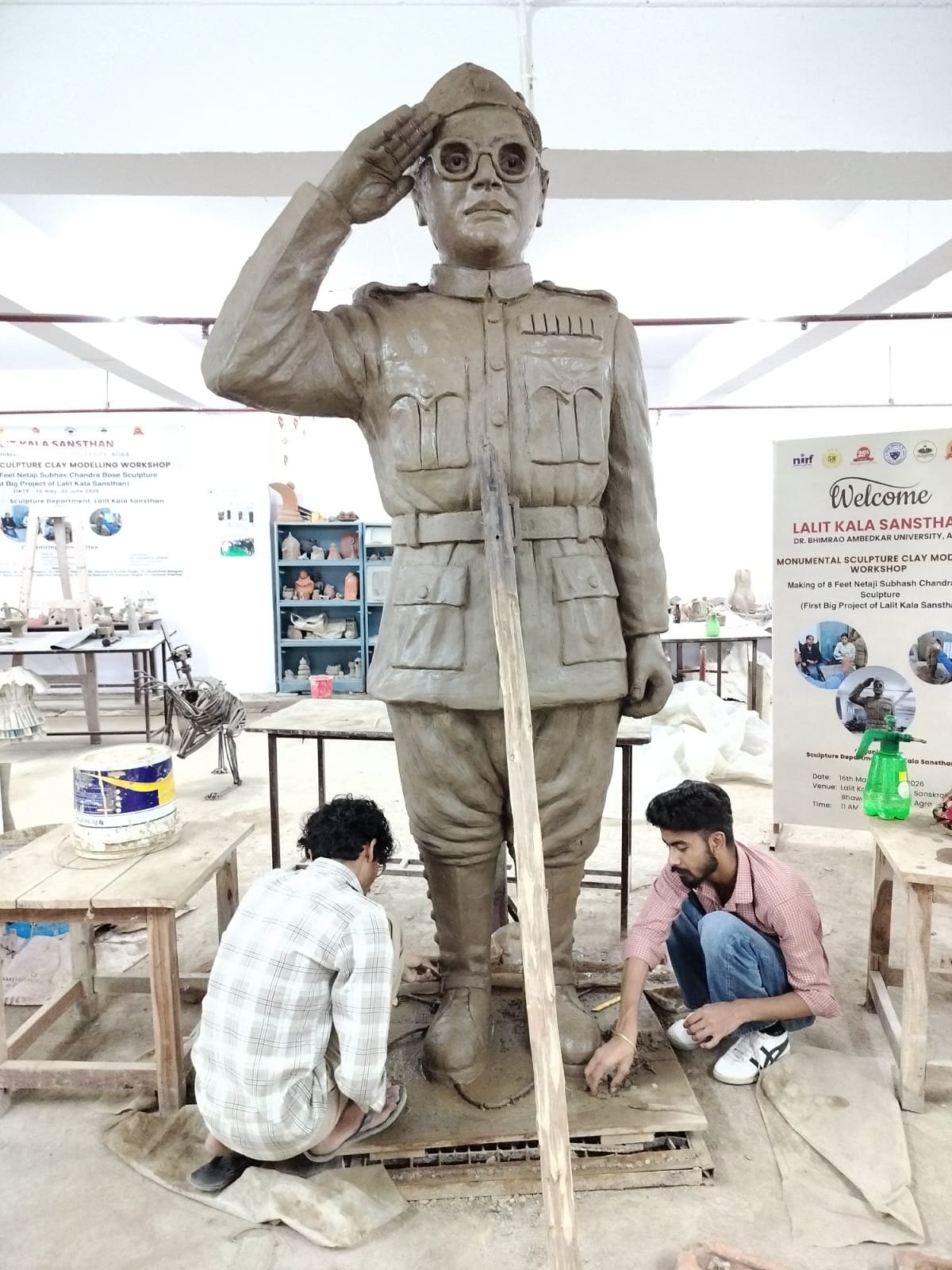 Students and faculty of the Institute of Fine Arts at Dr. Bhimrao Ambedkar University Agra with an 8-foot clay sculpture created during a monumental sculpture workshop.