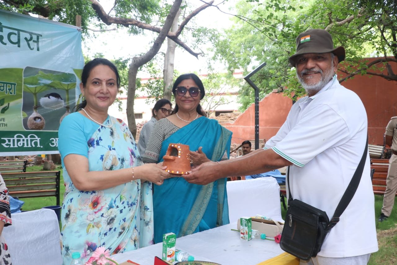 Participants taking a pledge for water conservation, environmental protection and plantation during a World Environment Day awareness program in Agra.
