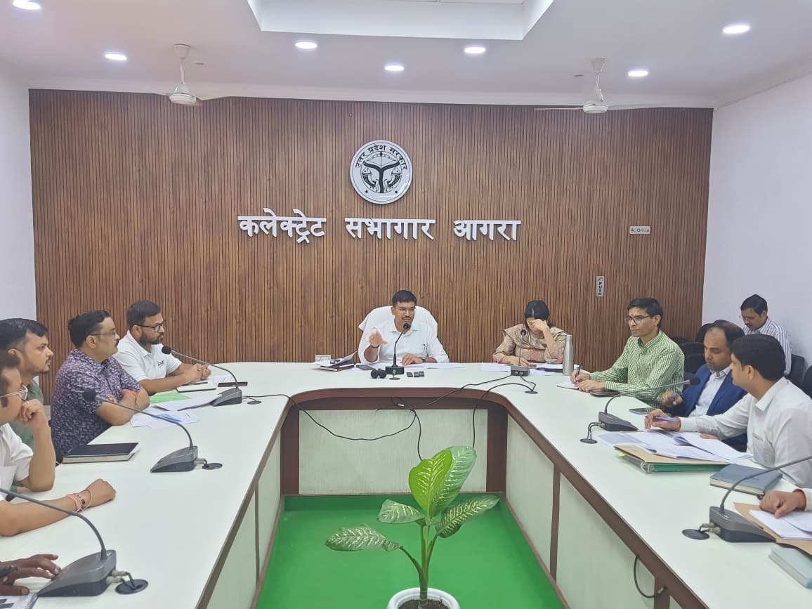 District officials and bank representatives attending PM Surya Ghar Yojana review meeting in Agra Collectorate auditorium.