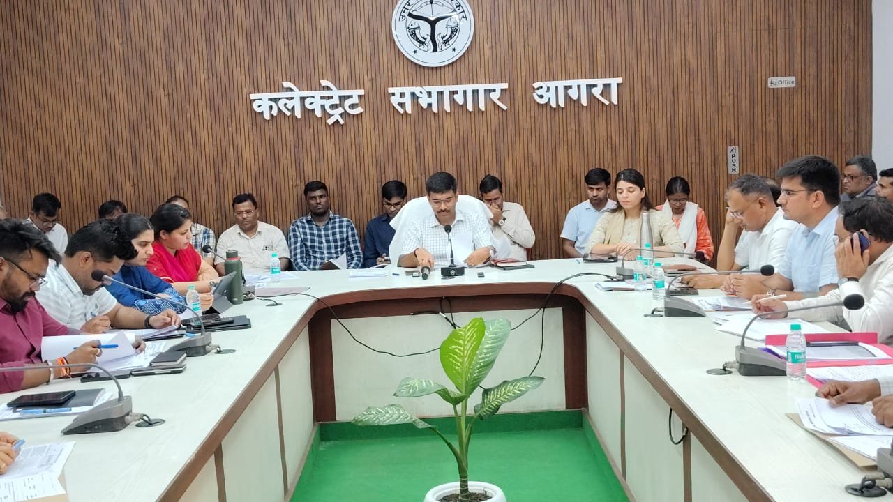 District Magistrate reviewing IGRS feedback and complaint disposal reports during meeting in Agra collectorate auditorium