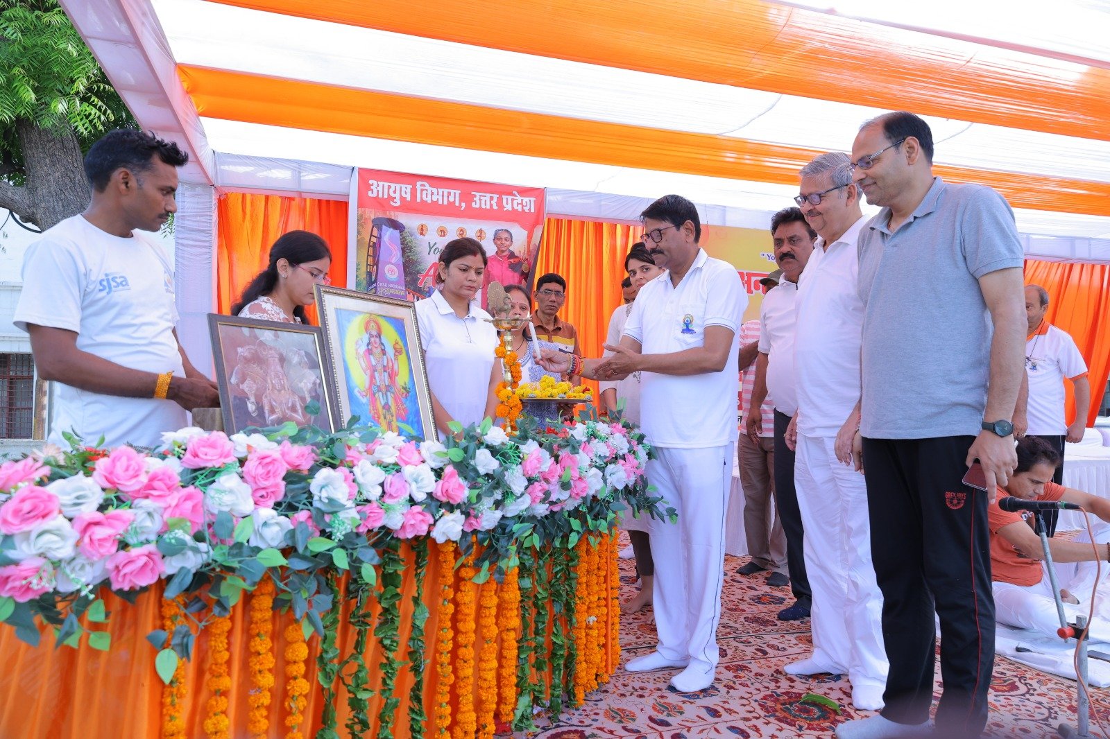 People performing mass yoga session during Yoga Week inauguration at Eklavya Sports Stadium in Agra.