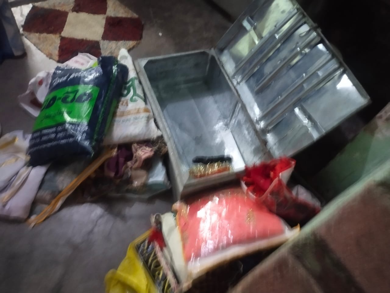 Police inspect a vacant house after thieves broke the gate latch and searched cupboards and trunks in Khatik Mohalla, Fatehabad.