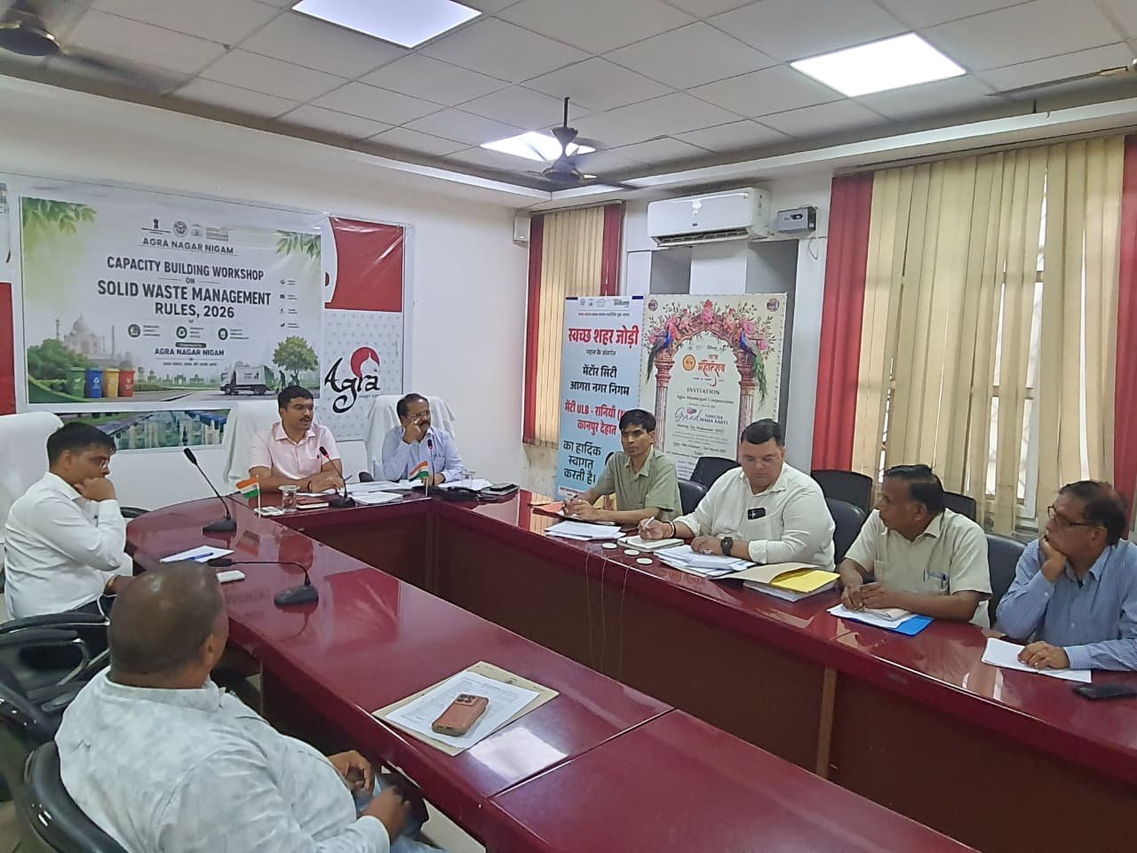 Agra District Magistrate Manish Bansal chairs a review meeting on CM Grid road development projects at the Smart City auditorium with officials and contractors.