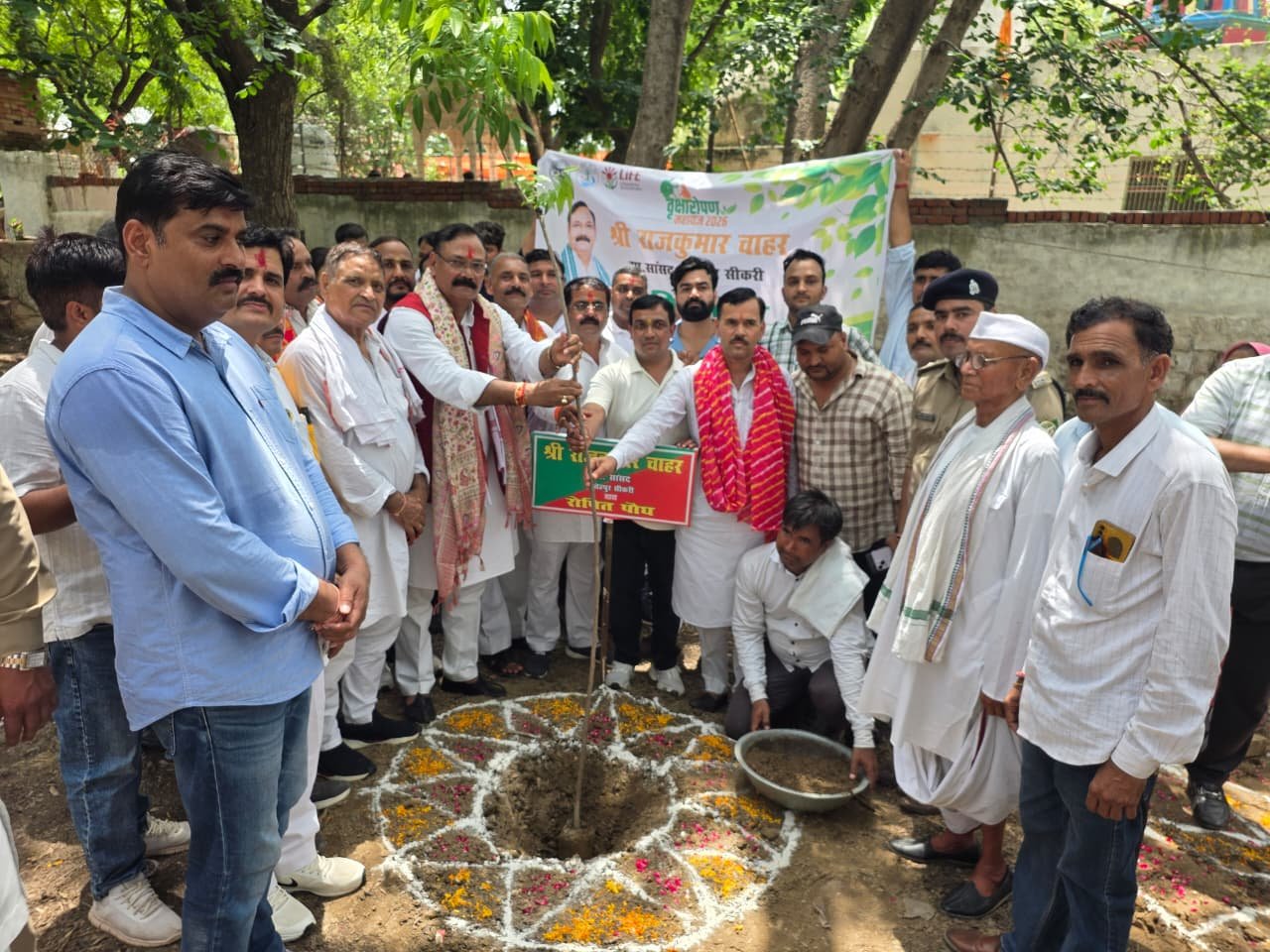 Rajkumar Chahar plants a sapling during the Ek Ped Maa Ke Naam tree plantation campaign at Kadamkhandi Temple in Ikram Nagar, Fatehpur Sikri, Agra.