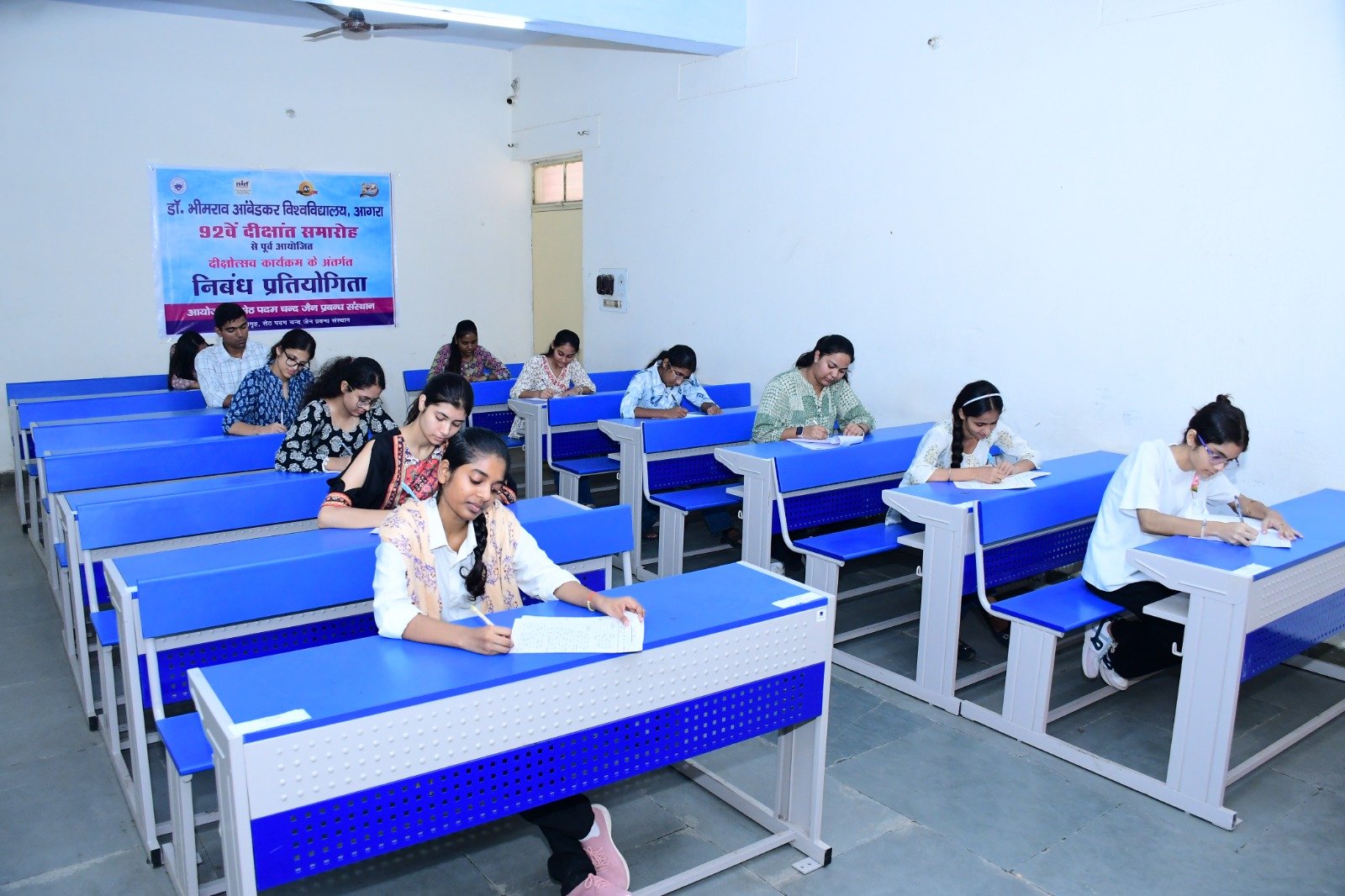 Students participate in the essay writing competition organized ahead of the 92nd Convocation at Dr. Bhimrao Ambedkar University, Agra.