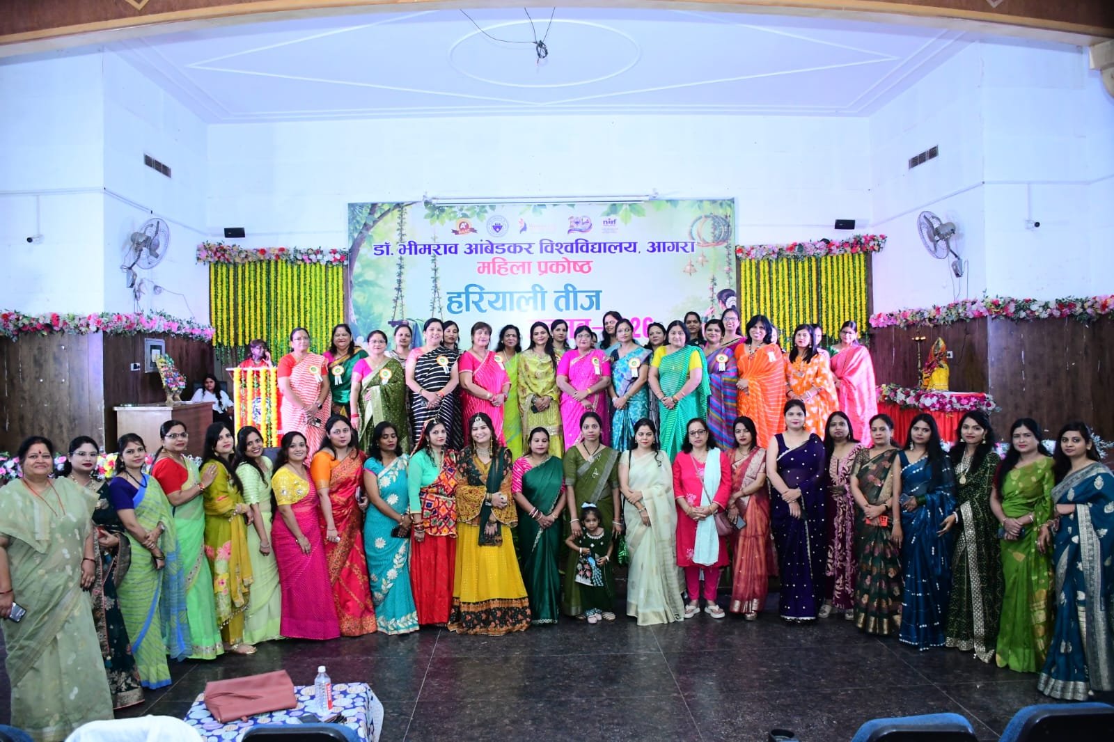 Women employees participating in Hariyali Teej Utsav 2026 at Dr Bhimrao Ambedkar University Agra