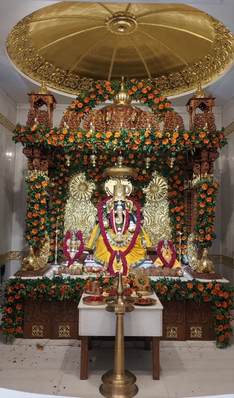 Peetambar-clad Mahaganpati adorned with gold ornaments during Ganesh Mahotsav