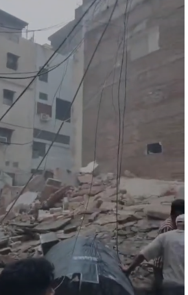 Rescue teams conducting an operation after a five-storey building collapsed in Satya Niketan Delhi