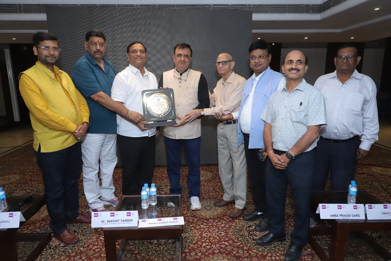 Chamber officials felicitating cyber expert Rakshit Tandon with a memento in Agra.