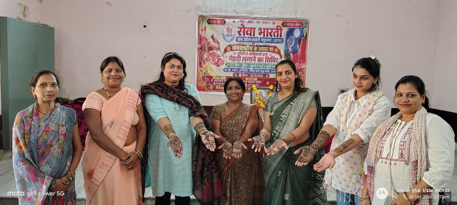 Seva Bharti trained girls applying mehndi to women during Karwa Chauth camp in Agra